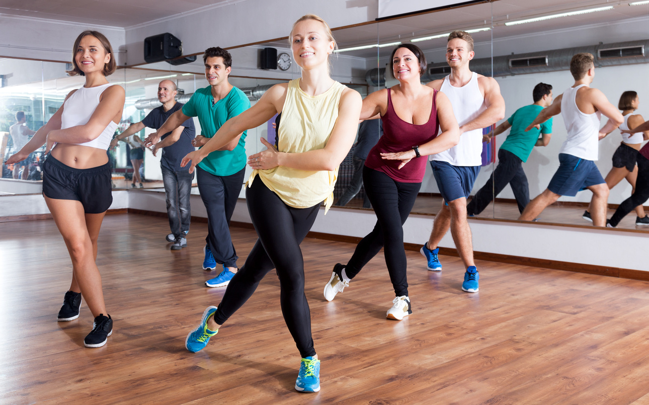 Adults having group fitness class